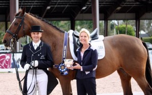 Ann-Louise Cook presents Lars Petersen with the first People’s Choice Award of the 2015 Adequan Global Dressage Festival 